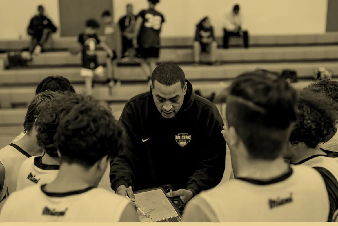 A Ballstars coach drawing up a play in the huddle