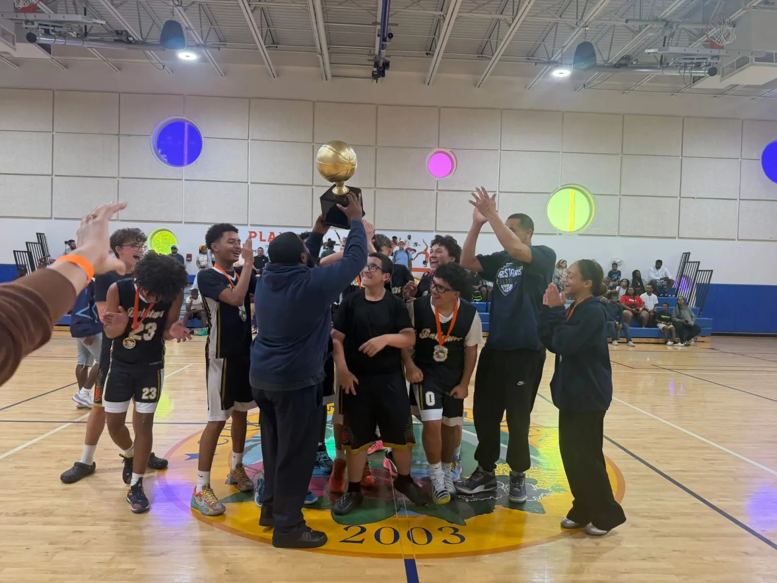 Ballstars players and coaches celebrating together in the gym