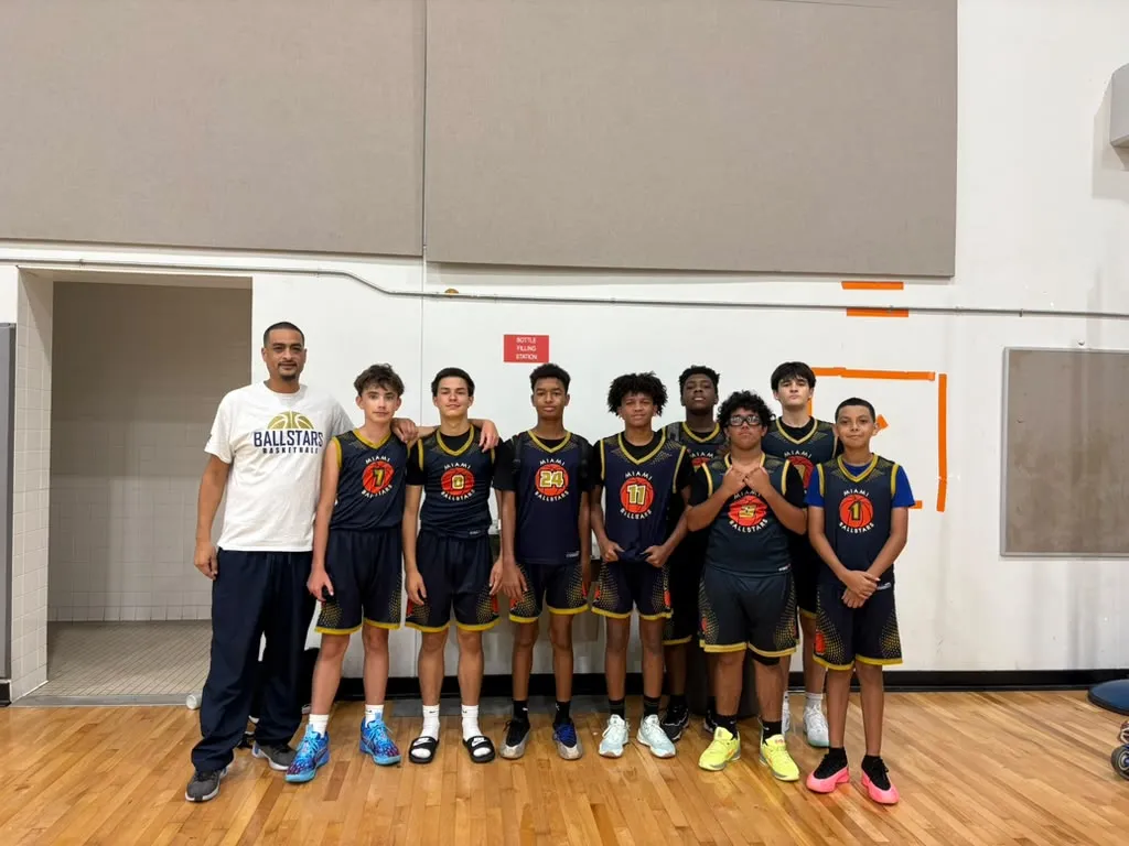 A Ballstars team in navy jerseys lined up with their coach